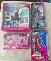 Group shot of all four boxed Barbie dolls