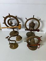 All four brass tabletop gongs with wood strikers