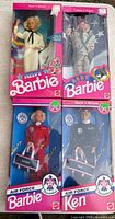 Group shot of four boxed military Barbie and Ken dolls