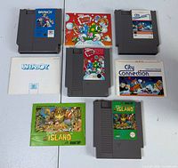 Four NES cartridges and four manuals laid out together
