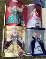 All four boxed Holiday Barbie dolls displayed together