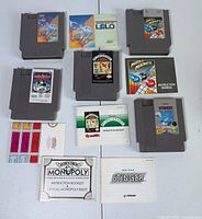 Overview of five NES cartridges with manuals and paperwork
