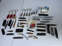 Overview of all miniature knives laid out on table