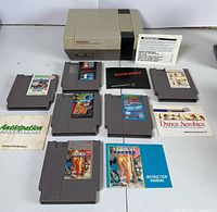 Overall view of NES console, six cartridges, manuals, and insert
