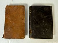 Front covers of both books showing different bindings and wear
