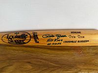 Close-up of barrel showing Louisville Slugger logo, Pete Rose signature, inscription