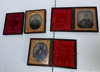 Four case halves displayed showing two assembled daguerreotypes and extra cover