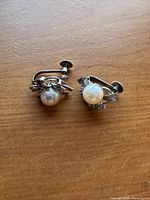 Front view of both pearl earrings showing bow mounts