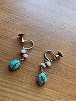 Full view of both earrings showing screw backs, stones, and beads