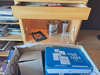 Cabinet section with ice bucket, shaker, glasses and box of candles