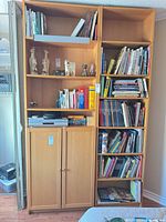 Two tall wooden bookcases filled with books across eight sections