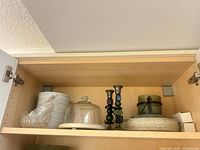 Shelf view showing candlesticks, cheese plate with dome, bowls