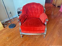 front view of red velvet tufted wood armchair