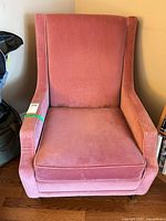 Front view of pink upholstered arm chair