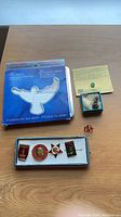 All items grouped: stamp tin, small box with pins, USSR pin case