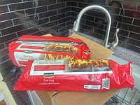 Two of the three Selection fire logs in red packaging on countertop