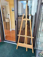Full view of wooden A-frame easel standing on floor