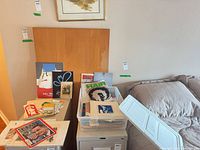 Overall lot showing plastic bin filled with prints and ephemera on cabinet