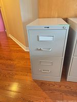 front view showing two drawers, handles, lock