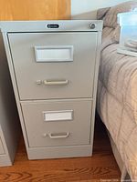 Front view of Global two-drawer filing cabinet showing drawers, handles, label holders, lock