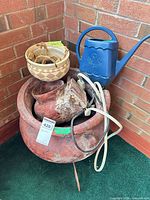 Fountain pot on stand with watering can, planter visible