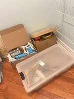 Overall lot with tote, boxes, hangers visible