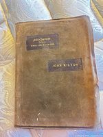 Front cover showing suede material and gilt title labels