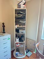 Tall shelf unit filled with binders, office supplies and accessories