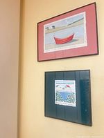 Both framed watercolor artworks on wall