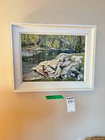 Full view of framed landscape painting on wall
