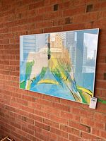 Full view of framed bird print on brick wall