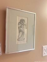 Full view of framed lithograph on wall