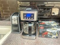 Coffee maker centered with can opener and boxed pasta machine