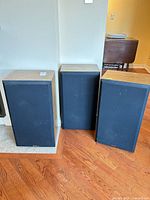Three speakers side by side showing overall design and size