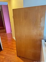 Front face of tabletop showing wood laminate finish