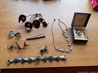 All seven sterling pieces laid out on table