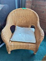 Front view of wicker armchair with cushion