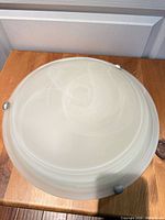 Top view showing 12-inch frosted opal glass shade with brushed nickel clips