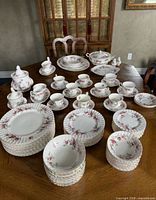 Entire dinnerware set laid out on table showing quantity and variety of pieces