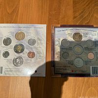 Backs of both sealed coin sets showing coin specifications in English and French