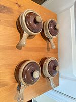 Top view of four handled soup bowls with lids