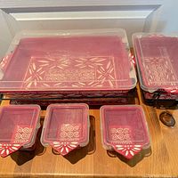 Full set showing two rectangular bakers with lids and racks, three small square dishes with lids