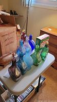 Group shot of all bottles, decanters, pig bottle on table