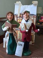 Front view of both Byers' Choice Carolers showing costumes and accessories