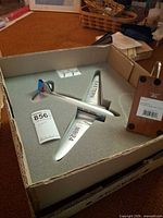 Model plane in foam packaging with stand and booklet visible