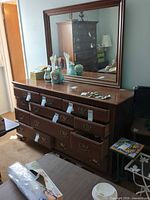 Full view of dresser with mirror and decorative items on top