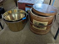 Wooden firkin bucket with two nested brass-tone pails side by side