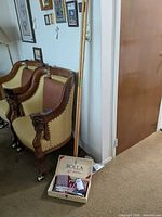 Long wooden poles beside box of mini flags