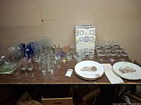 Overall lot on table with various stemware, boxed glasses, plates