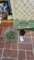 Boxed Arcoroc Emeraude green glass service alongside additional bowl and flower frog